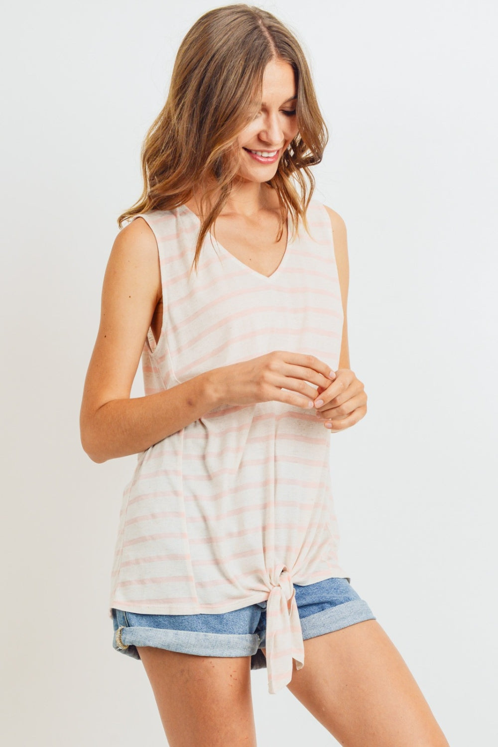 A sleeveless front tie striped top is a stylish and versatile piece for the warmer weather. This top typically features a sleeveless design, making it perfect for staying cool and comfortable on hot days. The front tie detail adds a fun and playful touch, allowing you to adjust the fit and create a customized look. S-XL