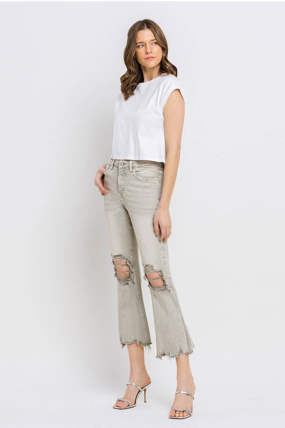 These distressed raw hem cropped flare jeans offer a perfect blend of edgy and retro style. The distressed detailing adds a touch of urban flair to the flared silhouette. The raw hem finishes off the look with a trendy, unfinished edge. Pair these jeans with a tucked-in graphic tee and platform sandals for a vintage-inspired outfit.  24-32