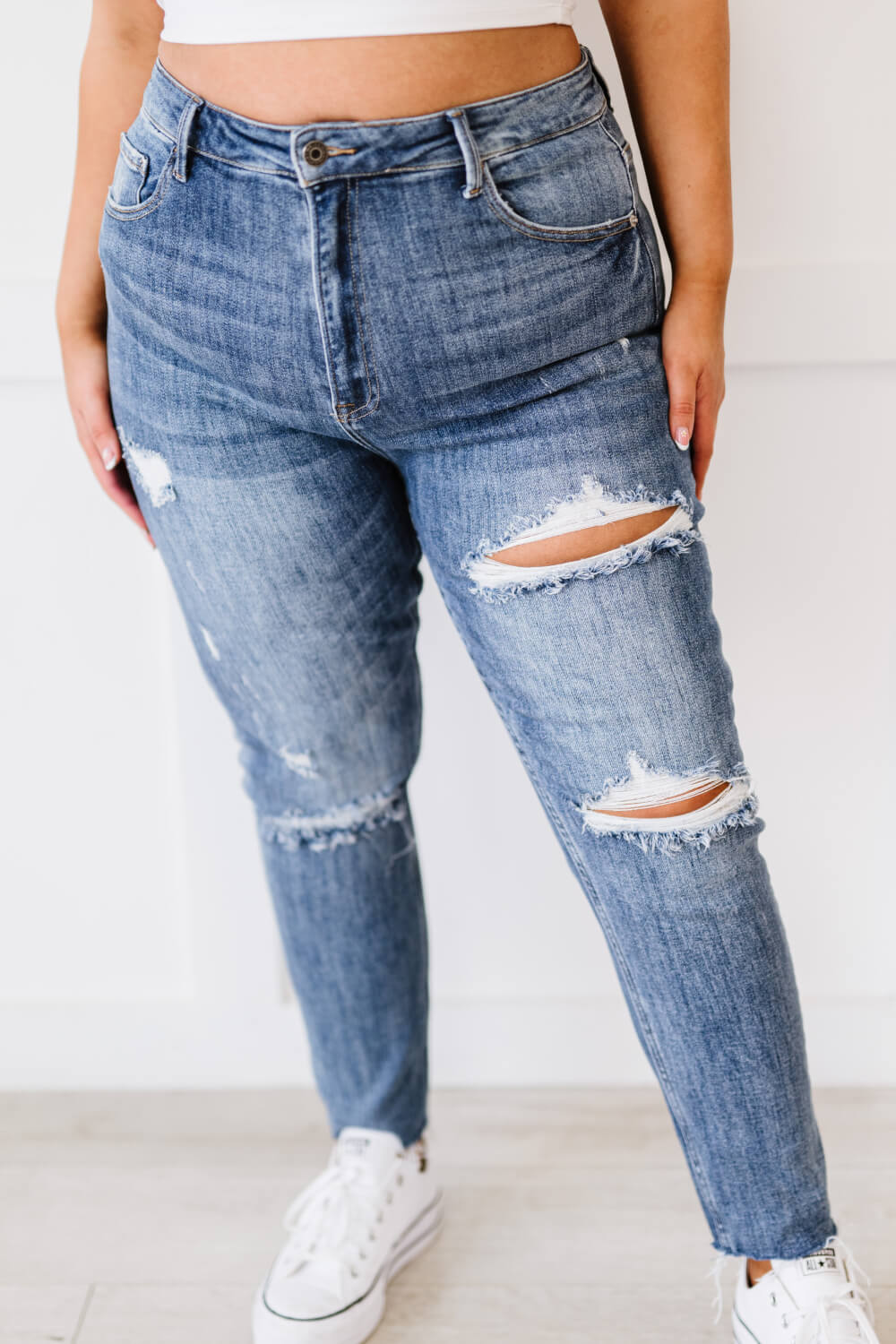 "Melissa Denim" are distressed skinny jeans that are the perfect addition to your wardrobe. They are comfortable and stylish, and can be dressed up or down. The distressed look is perfect for a casual day out, and the skinny fit will show off your curves. These are a medium wash. Sizes 3-11