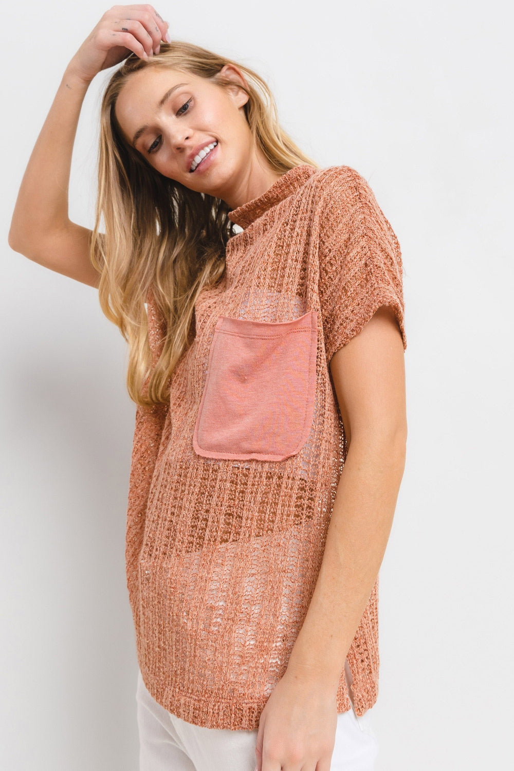 The See Through Crochet Mock Neck Cover Up is a stylish and versatile addition to your wardrobe. Perfect for layering over a swimsuit or pairing with a camisole for a boho-chic look. The intricate crochet detailing adds a touch of texture and visual interest. S-L