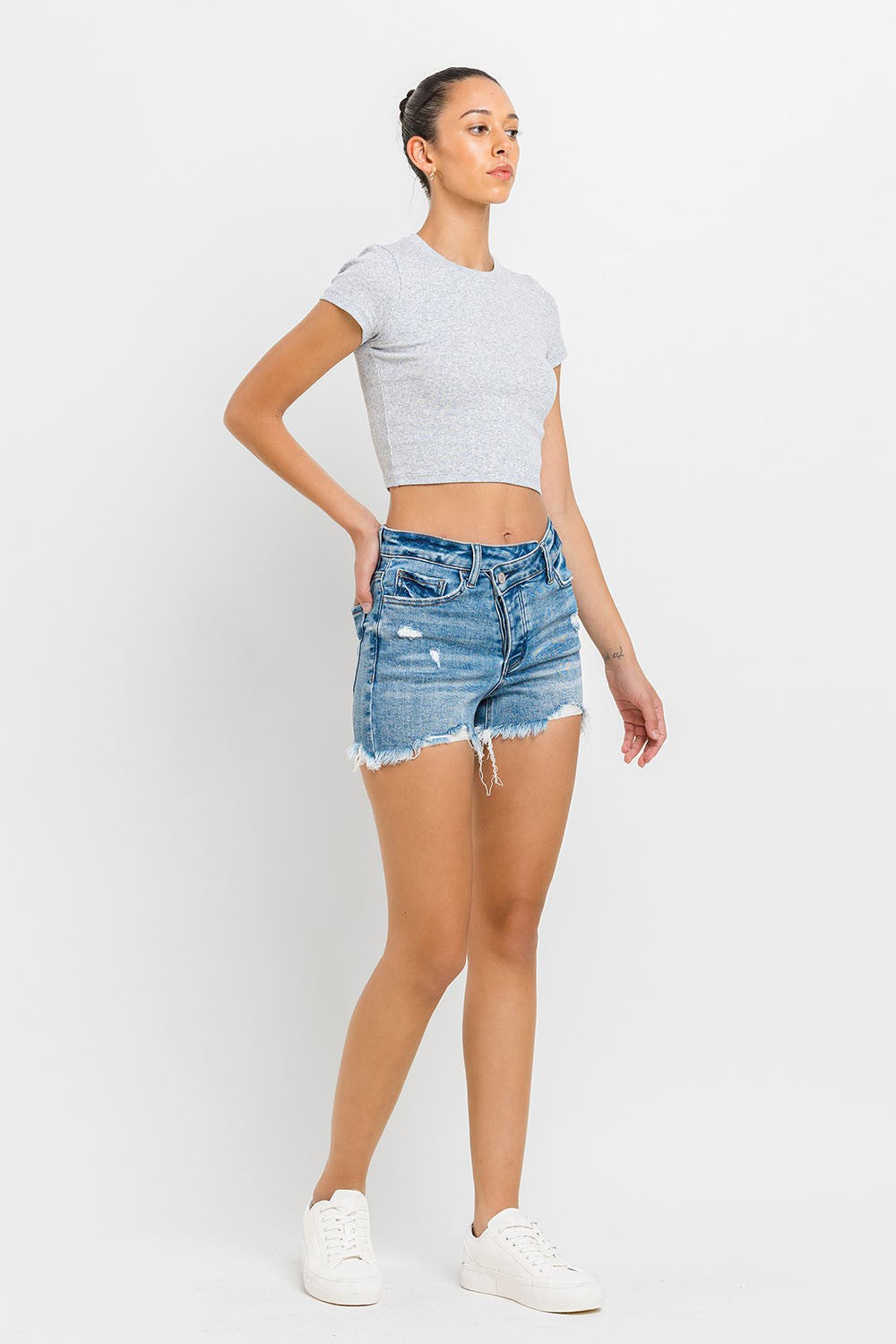 These stepped waist raw hem denim shorts are a chic and trendy addition to your summer wardrobe. The stepped waist design adds a unique twist to the classic denim shorts silhouette. The raw hem detail gives these shorts a cool, laid-back vibe. Pair them with a tucked-in tank top and sandals for a casual, effortless look. 