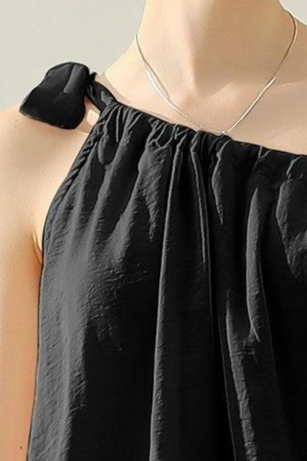 This elegant top features a unique one shoulder design with a bow tie strap, adding a touch of femininity to any outfit. Made from luxurious satin silk, it offers a smooth and luxurious feel against the skin. Perfect for both casual and formal occasions, this top is versatile and effortlessly stylish. S  -XL