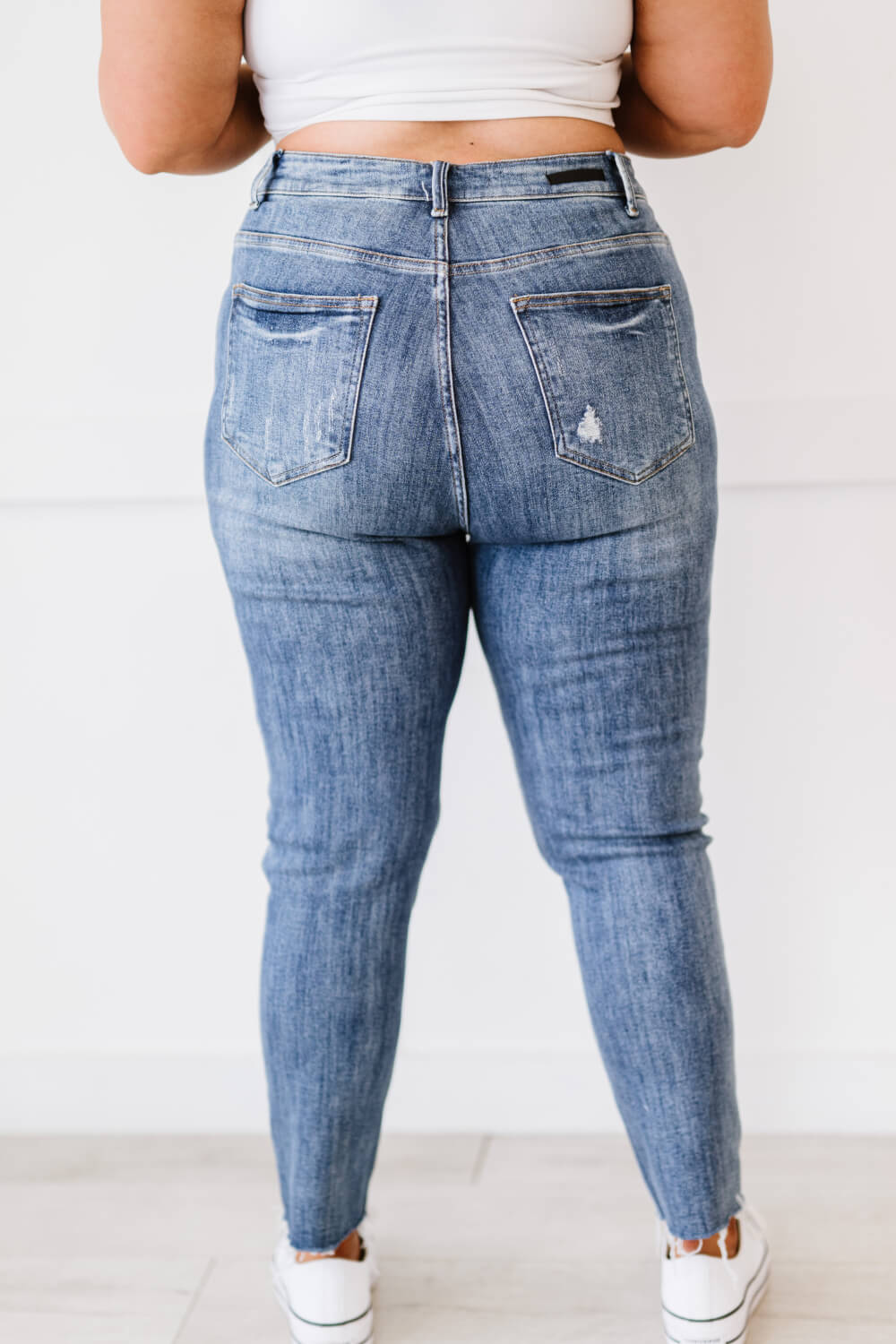 "Melissa Denim" are distressed skinny jeans that are the perfect addition to your wardrobe. They are comfortable and stylish, and can be dressed up or down. The distressed look is perfect for a casual day out, and the skinny fit will show off your curves. These are a medium wash. Sizes 3-11