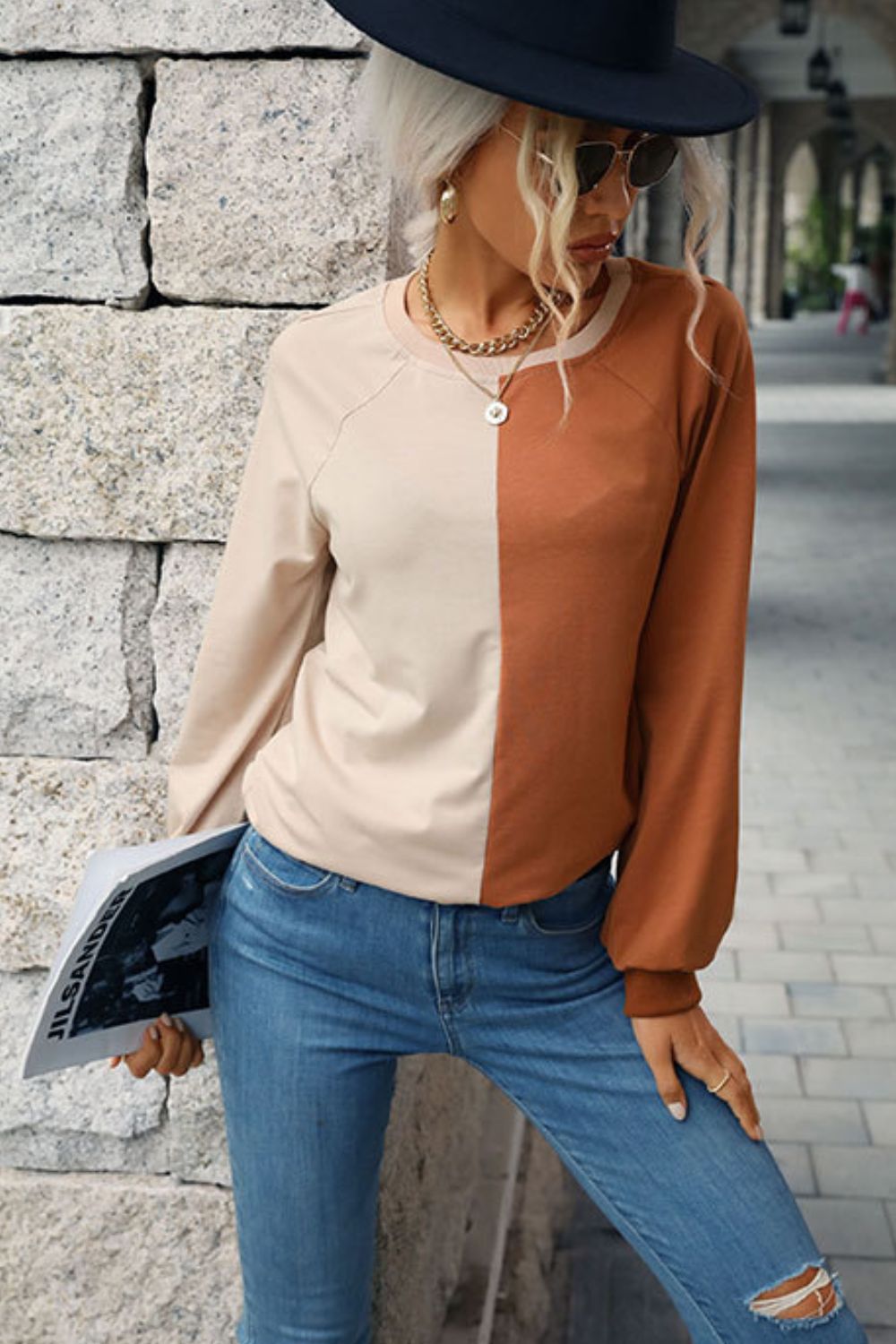 “Seeing Double” is a long sleeve sweatshirt featuring coloring blocking, round neckline, raglan sleeves, cuffed sleeves and hemline.The colors are khaki and brown. Sizes small through x-large.