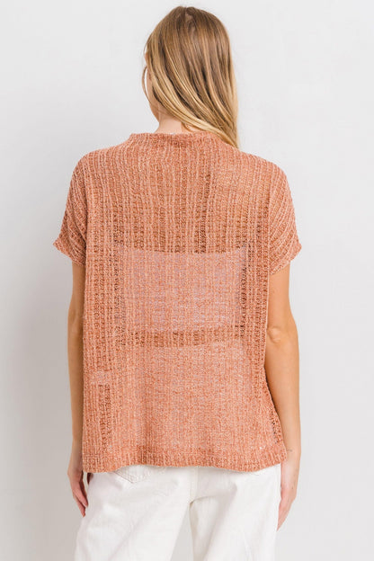 The See Through Crochet Mock Neck Cover Up is a stylish and versatile addition to your wardrobe. Perfect for layering over a swimsuit or pairing with a camisole for a boho-chic look. The intricate crochet detailing adds a touch of texture and visual interest. S-L