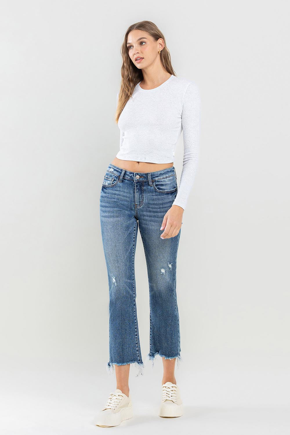 These mid rise frayed hem jeans are the perfect addition to any casual outfit. The frayed hem adds a trendy and edgy touch to the classic mid rise style. Made with high-quality denim, these jeans are both comfortable and durable. The mid rise waistline offers a flattering fit for all body types.