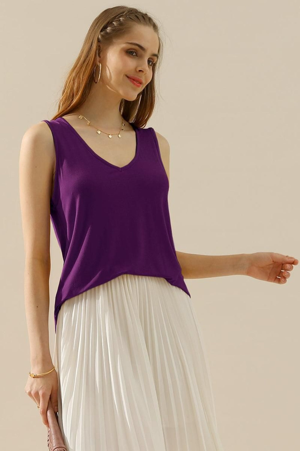 The V-Neck Curved Hem Tank is a stylish and versatile piece. With its flattering neckline and curved hem, it adds a touch of femininity to any outfit. The tank's relaxed fit provides comfort without sacrificing style. S - 3X