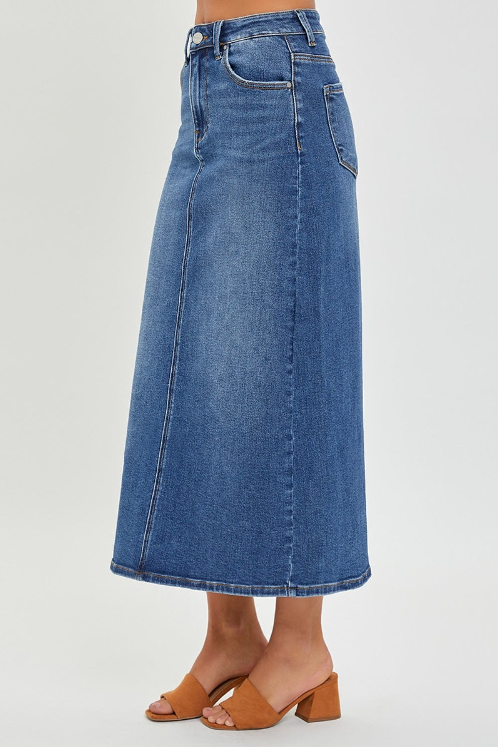 The High Rise Back Slit Denim Skirt is a stylish and versatile addition to your wardrobe. Made from high-quality denim, this skirt features a high-rise waist and a trendy back slit detail. Pair it with a tucked-in blouse and heels for a chic look, or dress it down with a graphic tee and sneakers for a more casual vibe. S  - XL