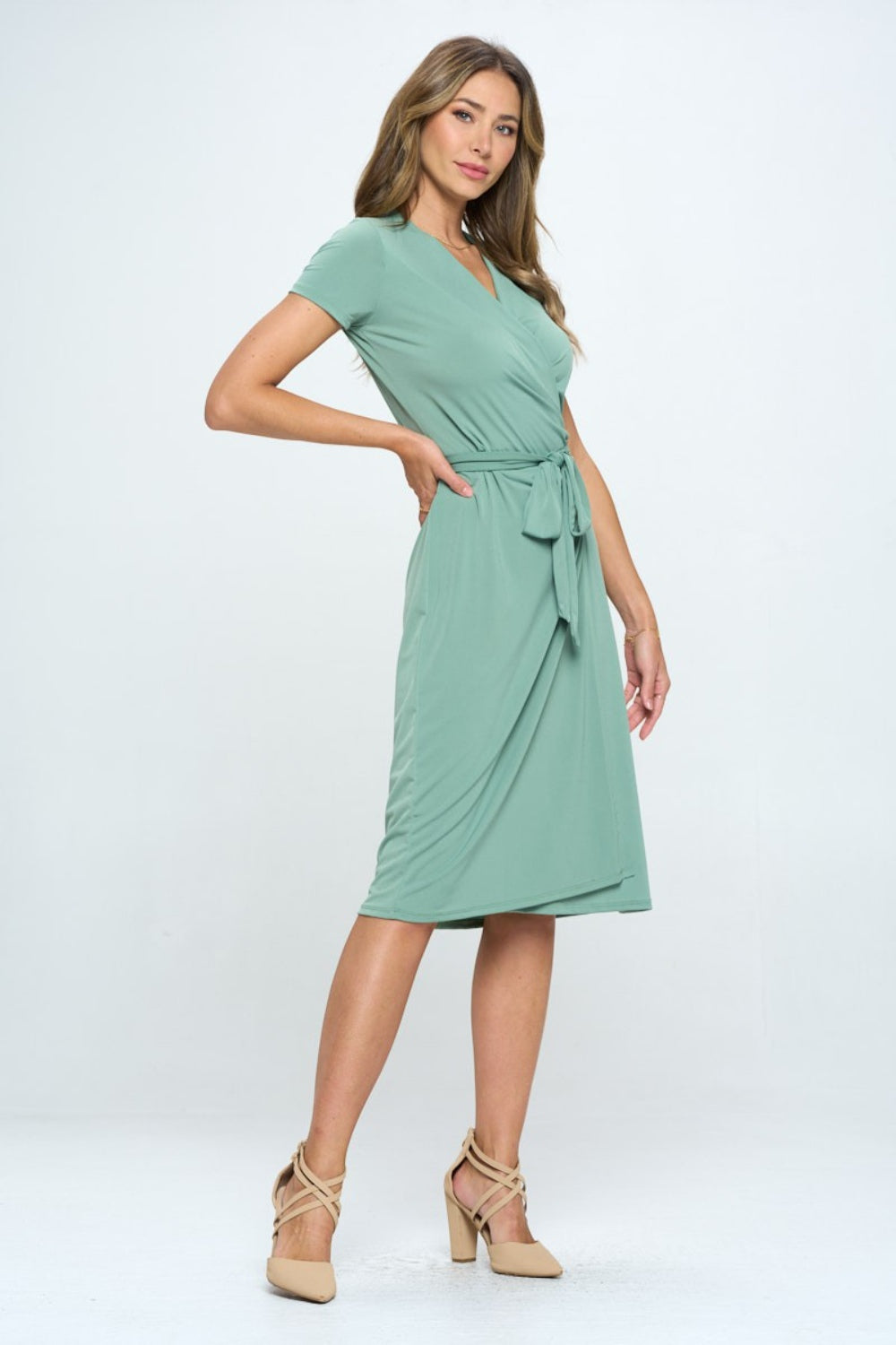 This tie front surplice short sleeve dress is a fabulous addition to your summer wardrobe. The surplice neckline creates a flattering silhouette while adding a touch of sophistication. The tie front detail at the waist adds a stylish and trendy element to the dress.  S  - L