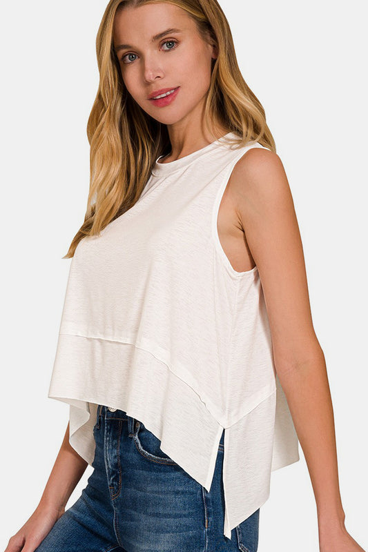 The Slit High-Low Round Neck Tank is a chic and trendy top that adds a touch of sophistication to any outfit. Featuring a stylish high-low hem with side slits, this tank offers a modern twist on a classic silhouette. The round neck design creates a flattering neckline, while the sleeveless style is perfect for warm weather or layering under a cardigan or jacket. 