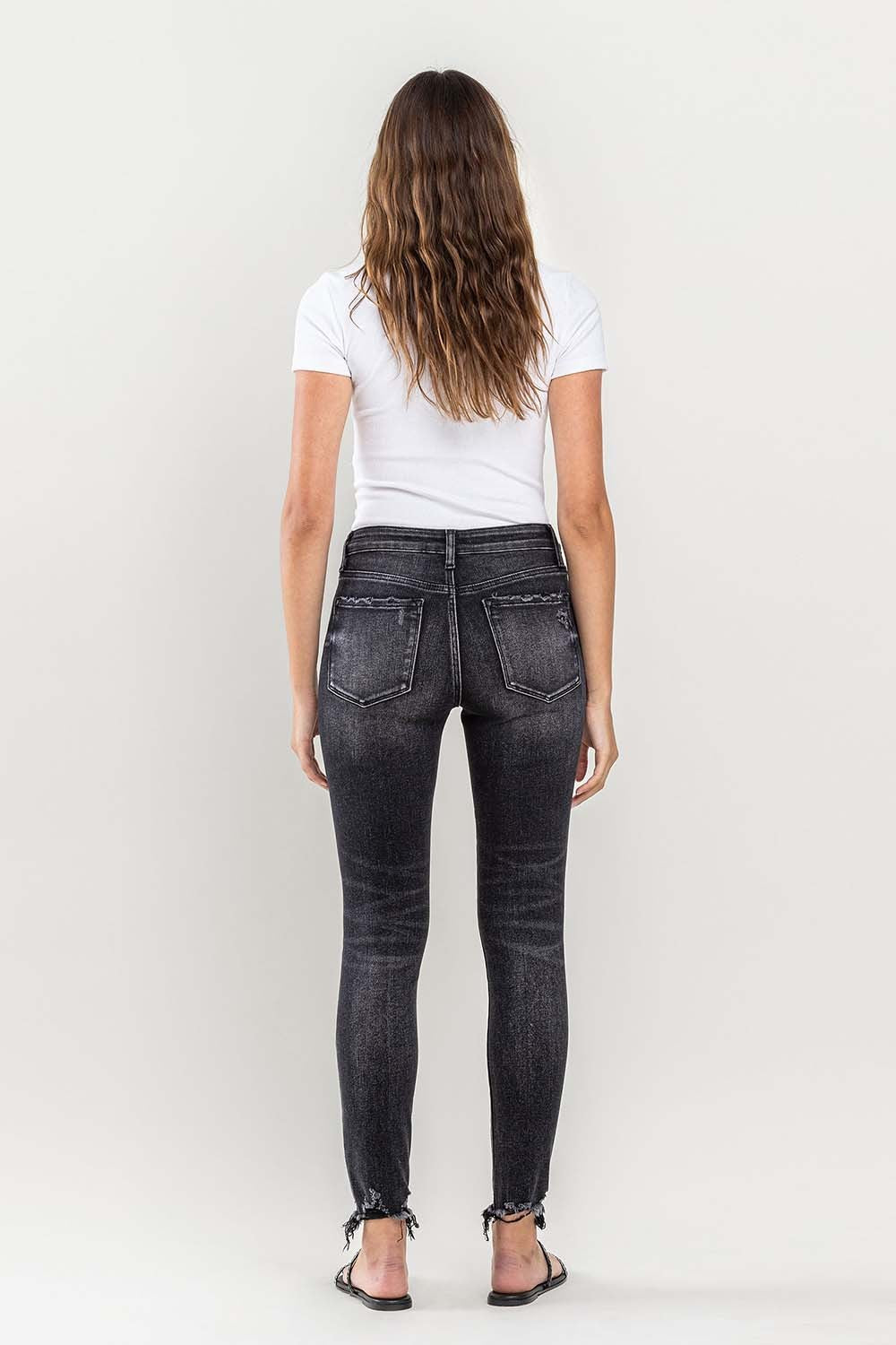 These raw hem cropped skinny jeans are a must-have for any fashion-forward individual. The raw hem adds a touch of edge to the classic skinny jeans silhouette. The cropped length is perfect for showcasing your favorite footwear. 24-32
