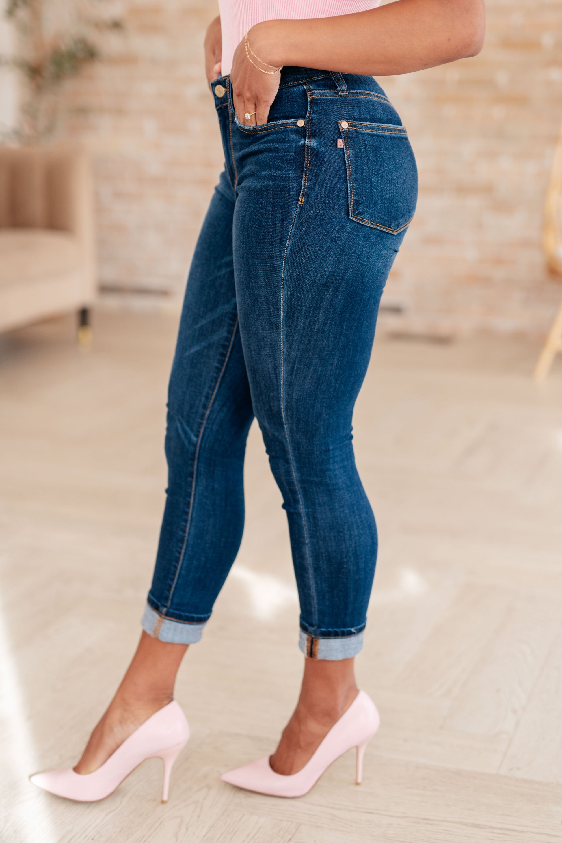 Upgrade your denim game with our Bette Mid Rise Vintage Cuffed Skinny Capri from Judy Blue! Enjoy the comfort of 4-way stretch and the timeless look of the dark vintage wash. Optional cuffed hems add a touch of style to this non-distressed, mid-rise jean. Perfect for a modern twist on a classic favorite. 0 -24W