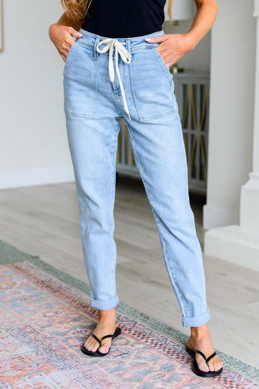 Get a retro-inspired look with our Cooper High Rise Vintage Denim Jogger! This jogger features a high rise design and a light wash for a vintage feel. The self-tie drawstring adds a touch of style, perfect for any casual outing. 0-24w