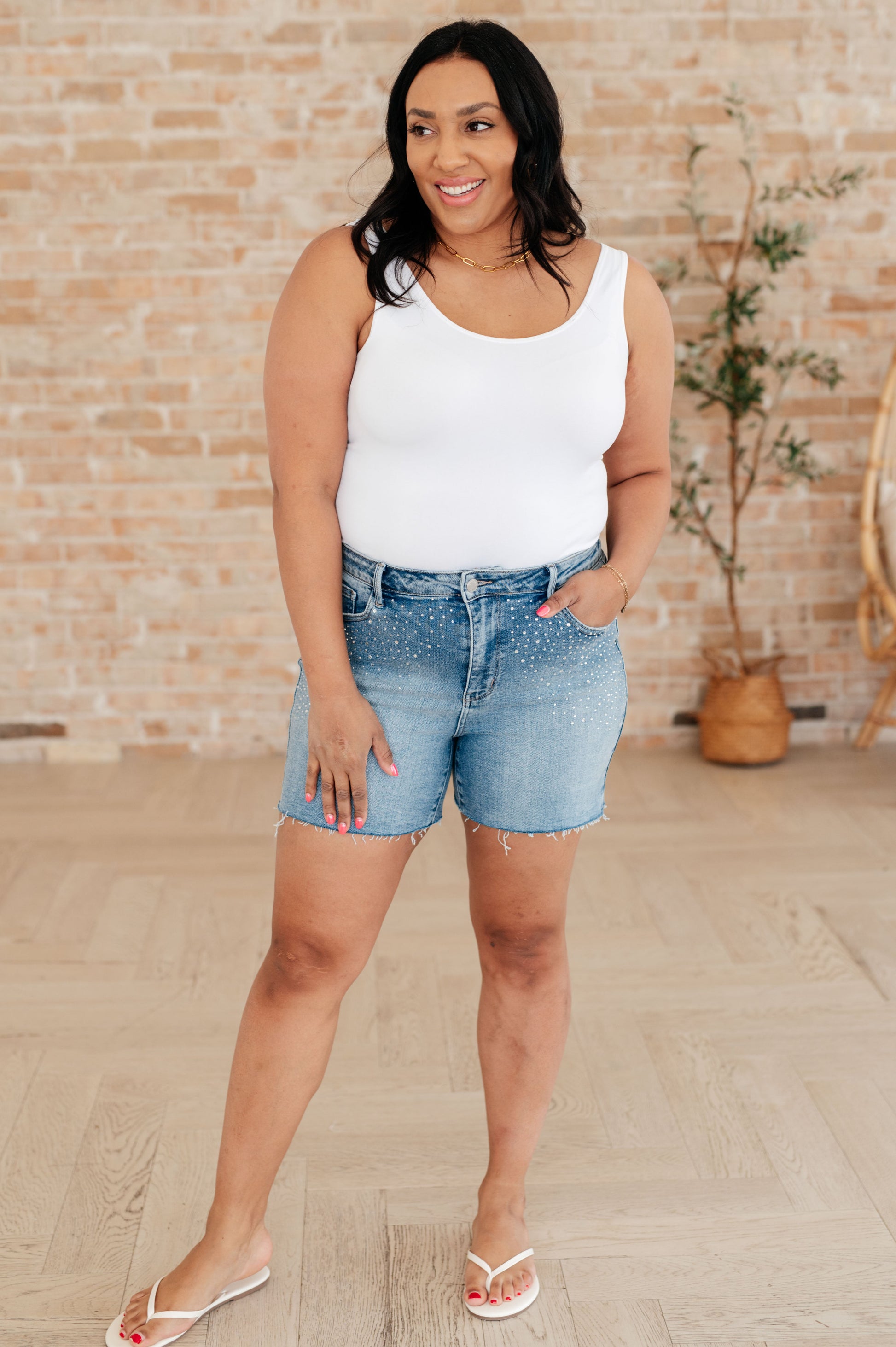 Elevate your style with Elle High Rise Rhinestone Cutoff Shorts. The high rise design flatters your figure, while the rhinestone embellishment adds a touch of sparkle. The raw cutoff hem and medium wash give a trendy, edgy vibe. Step out in confidence with these statement shorts. S-3X