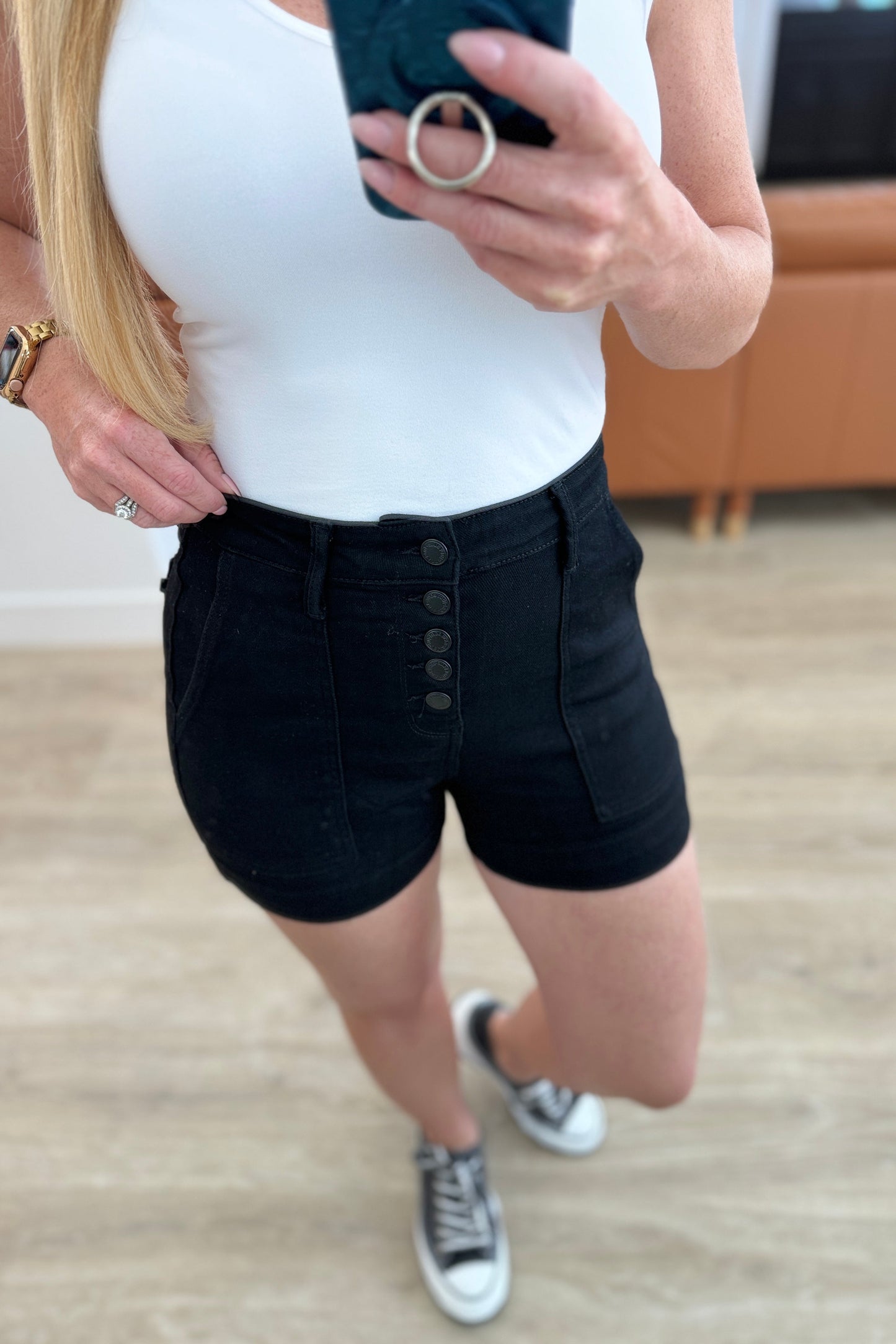 Step up your shorts game with the Reagan High Rise Button Fly Trouser Shorts from Judy Blue! These high-waisted shorts feature a coordinating button fly and a saturated black color for a sleek and stylish look. With trouser pockets and a non-distressed denim, these shorts are both functional and fashionable. Perfect for any summer occasion.&nbsp; S-3X