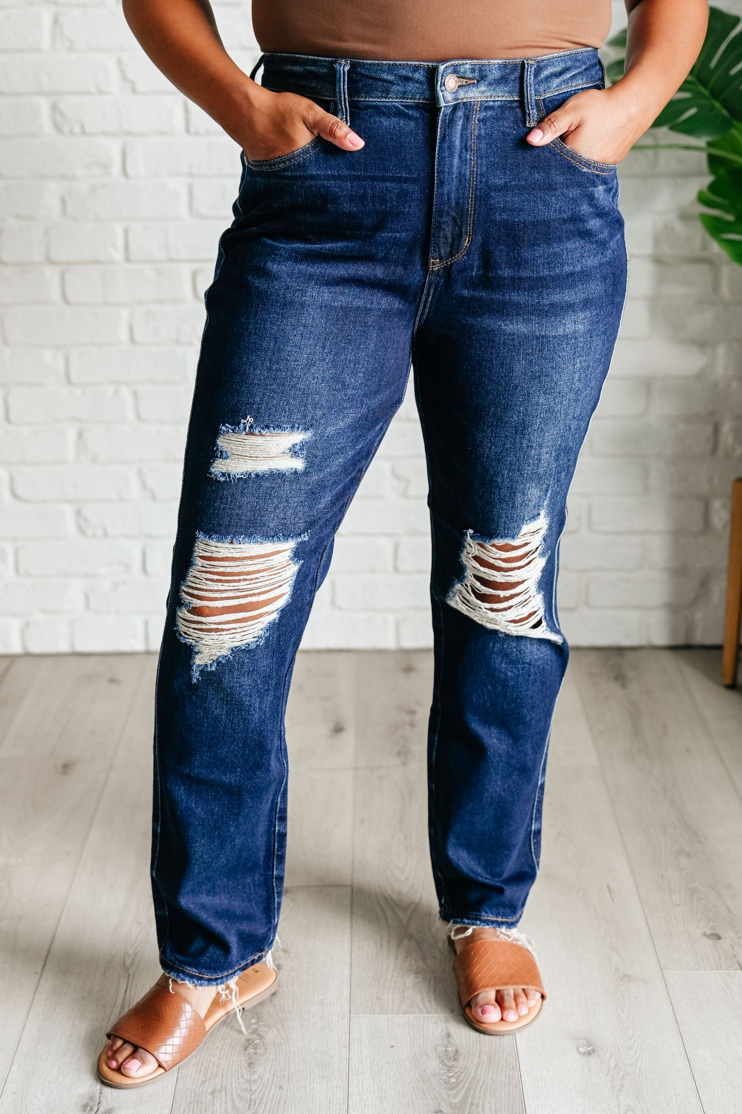 Experience the perfect blend of comfort and style with our Montana High Rise Rigid Magic Distressed Straight Jeans from Judy Blue! The high rise design and rigid magic construction provide a relaxed and flattering fit, while the dark wash and distressed details add a bit of edginess. Complete your look with these effortlessly cool jeans.