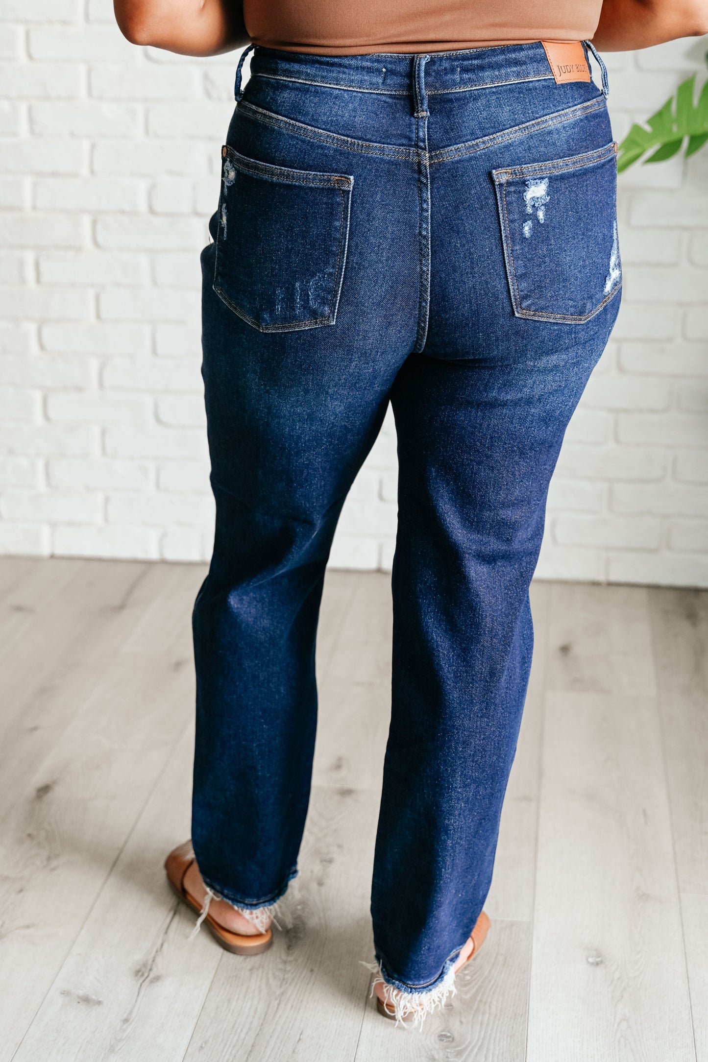 Experience the perfect blend of comfort and style with our Montana High Rise Rigid Magic Distressed Straight Jeans from Judy Blue! The high rise design and rigid magic construction provide a relaxed and flattering fit, while the dark wash and distressed details add a bit of edginess. Complete your look with these effortlessly cool jeans.