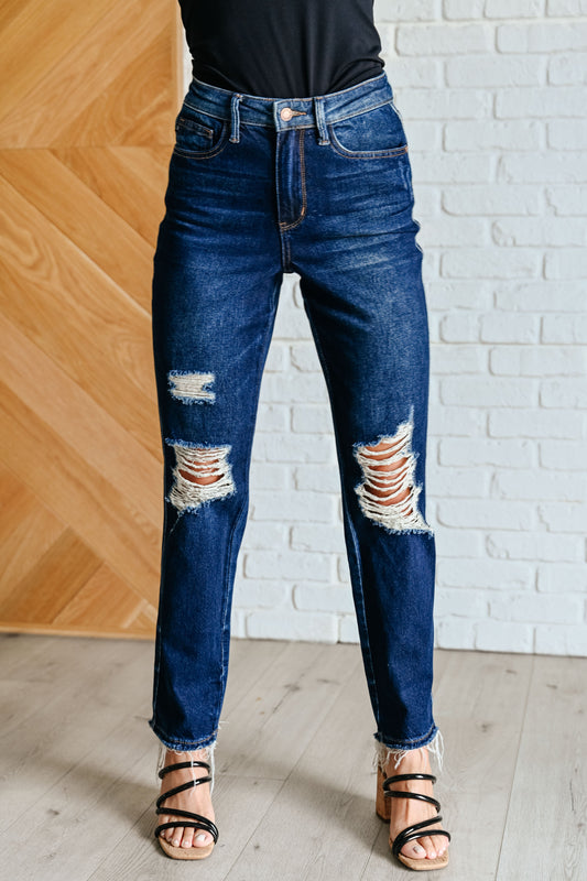 Experience the perfect blend of comfort and style with our Montana High Rise Rigid Magic Distressed Straight Jeans from Judy Blue! The high rise design and rigid magic construction provide a relaxed and flattering fit, while the dark wash and distressed details add a bit of edginess. Complete your look with these effortlessly cool jeans.