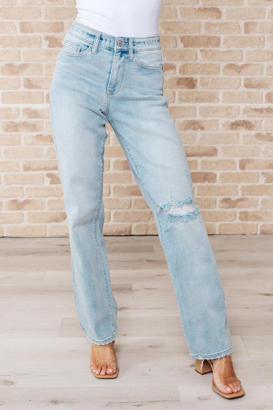 Rock the hottest trend with the Parker High Rise 90's Straight Jeans! Featuring a light wash and distressed front and back, these jeans offer a unique and stylish look. Their high rise and 90's straight silhouette provide a flattering fit for any body type. Upgrade your wardrobe with these must-have jeans! 0-24W