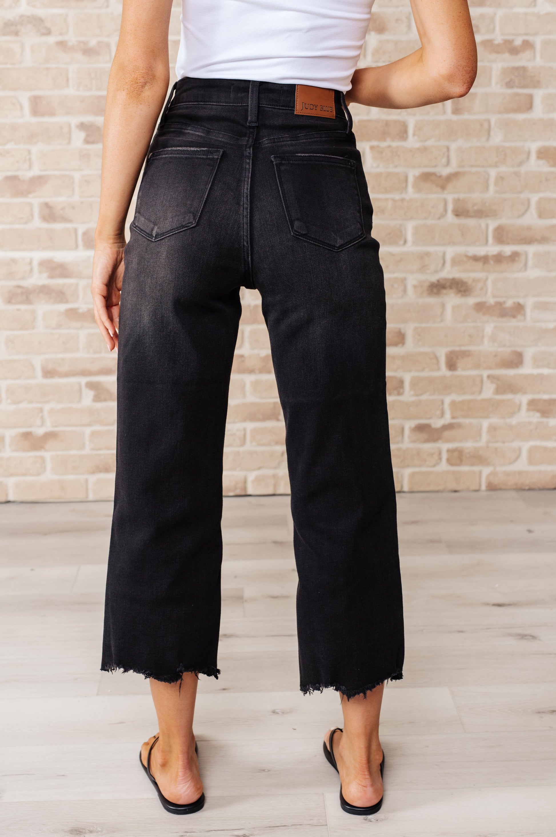 Get ready to rock stylishly with Ryan High Rise Jeans! These wide leg crop jeans feature a coordinating button fly and a washed out black garment dye for a cool, edgy look. With a high rise and raw hem, you'll stand out in the best way possible.&nbsp; 0-24W