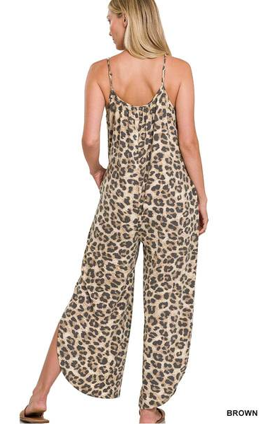 Leopard jumpsuit with side slits, adjustable straps, functional pockets. Sizes small through x-large.
