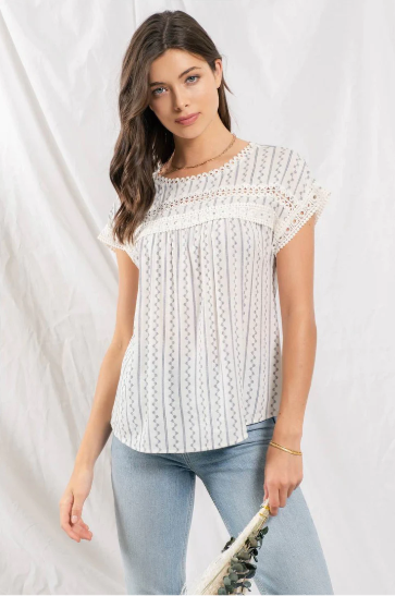 Feel flirty and fun in our Zig Zag Top! This cute top has an eye catching lace trim round neckline, extended shoulders, and dolman sleeves with lace trim. Plus, the front lace inset detail and back non-functional buttons will keep heads turning! Who says fashion can't be playful? Sashay into the room in this statement piece!