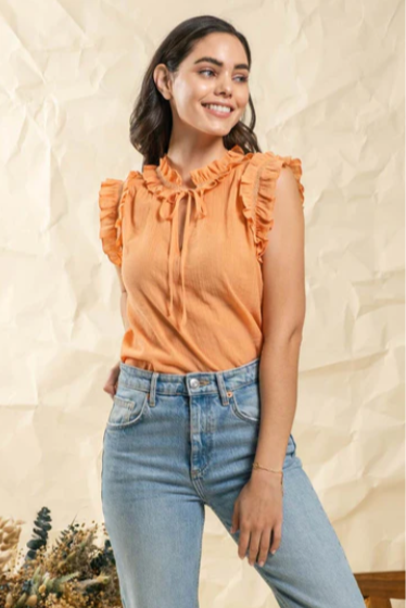Make a splash this summer with this "Fun In The Sun Dusty Apricot" top! Indulge in the split neckline with self tie, and dance the day away with the ruffles and lace detail that flutter along the neck and arm openings. Time to unleash your carefree summer spirit!