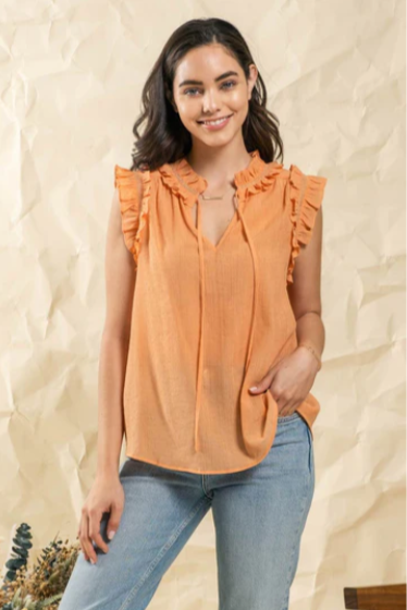 Make a splash this summer with this "Fun In The Sun Dusty Apricot" top! Indulge in the split neckline with self tie, and dance the day away with the ruffles and lace detail that flutter along the neck and arm openings. Time to unleash your carefree summer spirit!