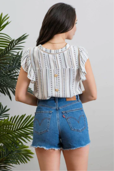 Be cool and breezy with this chambray-inspired Cindy Ivory & Blue Patterned Top! Its v-neckline and short ruffle sleeves with lace trim give it a sweet and sassy look. The back yoke and non-functional buttons round out the look, with a subtle hint of western-style flair. Yee-haw!!