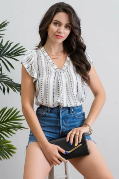 Be cool and breezy with this chambray-inspired Cindy Ivory & Blue Patterned Top! Its v-neckline and short ruffle sleeves with lace trim give it a sweet and sassy look. The back yoke and non-functional buttons round out the look, with a subtle hint of western-style flair. Yee-haw!!
