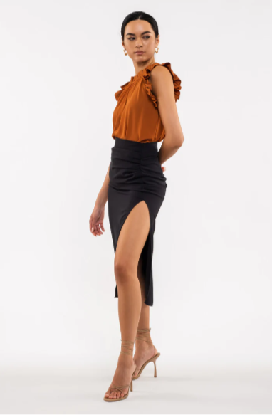Be your sassiest self in this sleeveless top featuring a perfectly folded, eye-catching ruffle! This rust-hued classic features a woven fabric - so go ahead and look ultra-chic with minimal effort. A top that'll have you sayin' "ruffle-it-up!" Sizes small  through large.