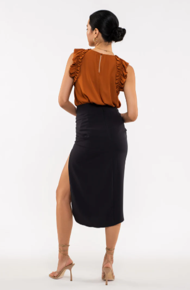 Be your sassiest self in this sleeveless top featuring a perfectly folded, eye-catching ruffle! This rust-hued classic features a woven fabric - so go ahead and look ultra-chic with minimal effort. A top that'll have you sayin' "ruffle-it-up!" Sizes small  through large.