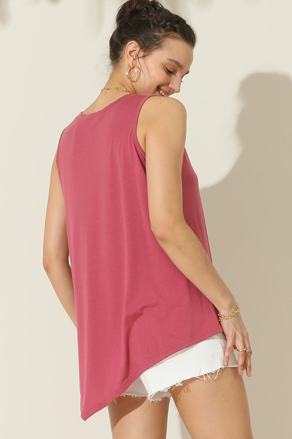The Buttoned Uneven Hem Tank is a stylish and contemporary addition to your summer wardrobe. With its button-front design and uneven hemline, this tank top offers a unique and trendy look. The button detailing adds a touch of sophistication, while the uneven hemline adds an element of asymmetry and visual interest.  S  - XL