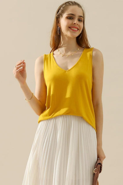 The V-Neck Curved Hem Tank is a stylish and versatile piece. With its flattering neckline and curved hem, it adds a touch of femininity to any outfit. The tank's relaxed fit provides comfort without sacrificing style. S - XL