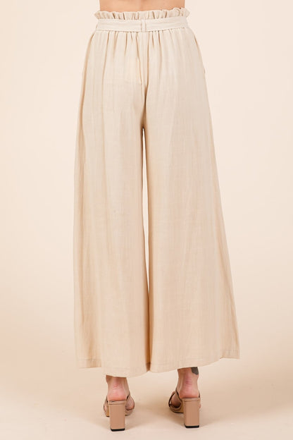 High Waist Tie Front Wide Leg Pants are a stylish and flattering bottom option that features a high waist and wide legs with a tie-front detail. The high waist design accentuates the waistline and creates a long and lean silhouette. The wide legs offer a flowy and relaxed fit, providing comfort and a chic look. S-L
