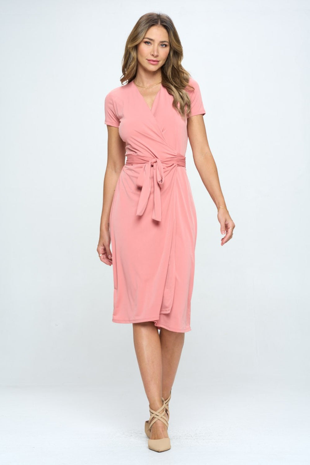 This tie front surplice short sleeve dress is a fabulous addition to your summer wardrobe. The surplice neckline creates a flattering silhouette while adding a touch of sophistication. The tie front detail at the waist adds a stylish and trendy element to the dress. S - L