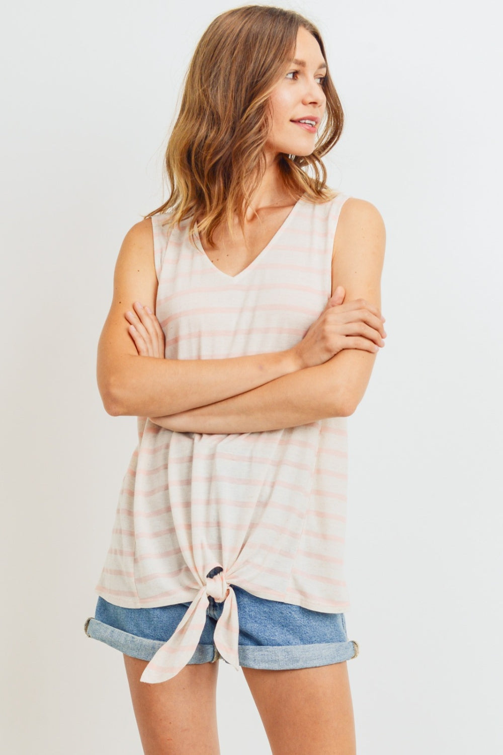 A sleeveless front tie striped top is a stylish and versatile piece for the warmer weather. This top typically features a sleeveless design, making it perfect for staying cool and comfortable on hot days. The front tie detail adds a fun and playful touch, allowing you to adjust the fit and create a customized look. S-XL