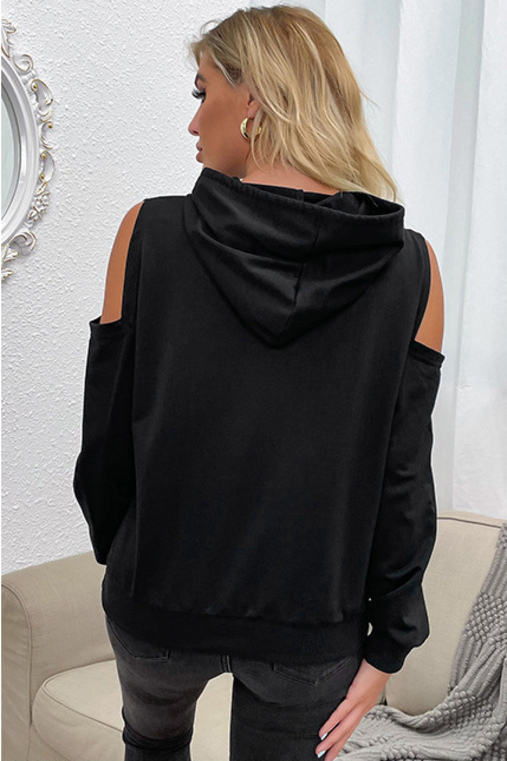 “Evening Errands” is a long sleeve top featuring colder shoulder peek-a-boo cutouts, hoodie with drawstring. Sizes medium through x-large.