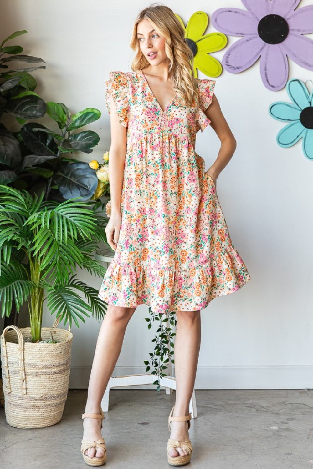 Introducing the Floral Ruffled V-Neck Dress. This stunning dress combines feminine elegance with a touch of playfulness. The floral pattern adds a romantic and vibrant flair, while the ruffled details create a whimsical and graceful look.