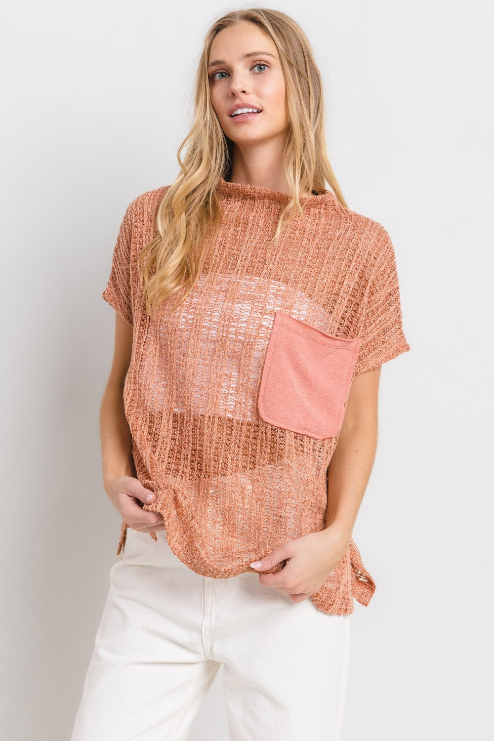 The See Through Crochet Mock Neck Cover Up is a stylish and versatile addition to your wardrobe. Perfect for layering over a swimsuit or pairing with a camisole for a boho-chic look. The intricate crochet detailing adds a touch of texture and visual interest. S-lL