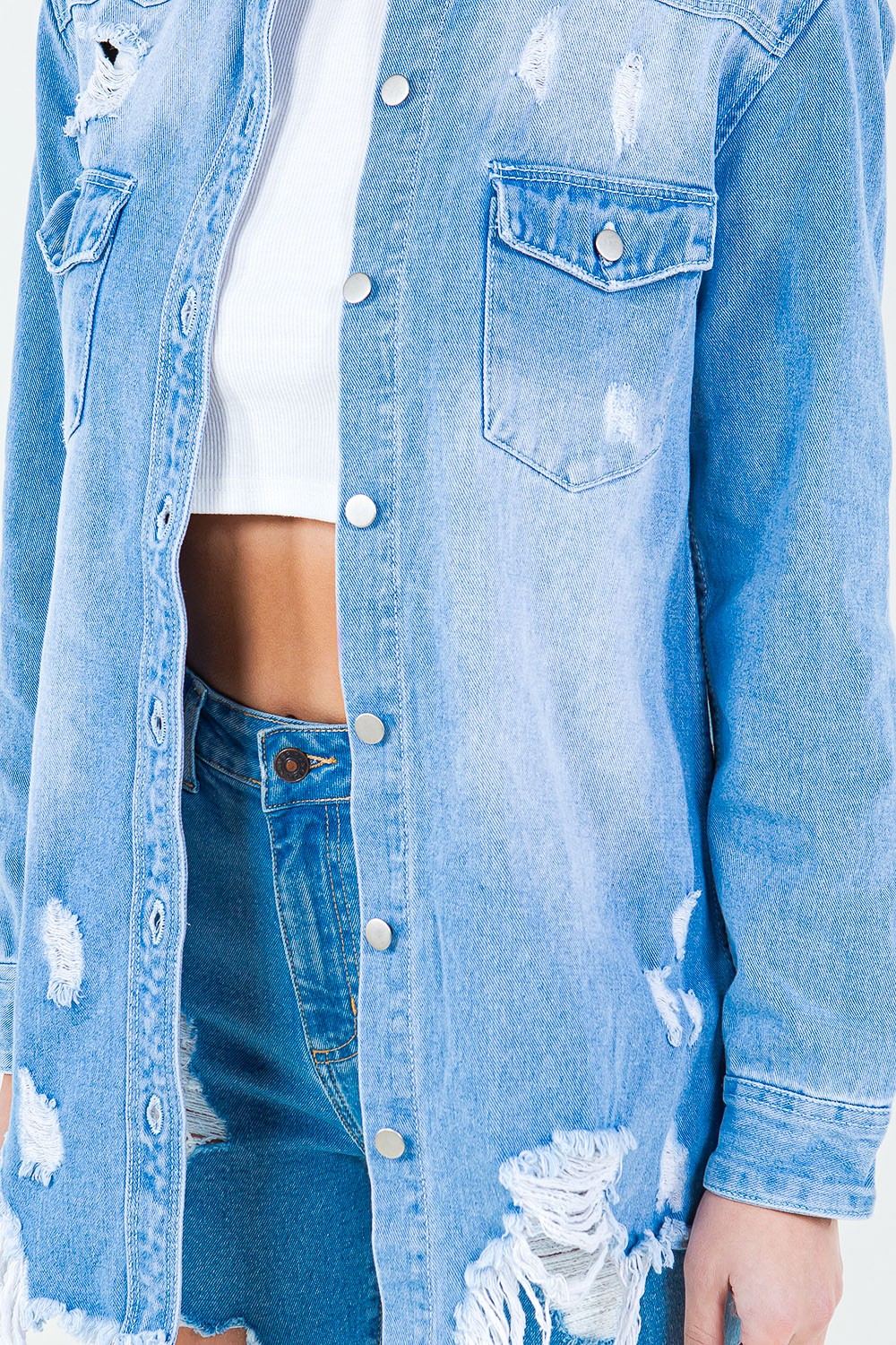 Introducing the Frayed Hem Distressed Denim Shirt Jacket. This stylish piece combines the timeless appeal of denim with a contemporary twist. The frayed hem adds a touch of edginess, while the distressed details create a worn-in look.  S - 3X