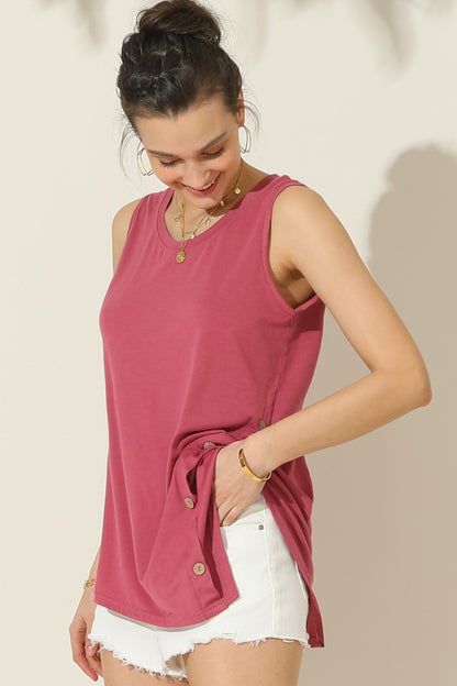 The Buttoned Uneven Hem Tank is a stylish and contemporary addition to your summer wardrobe. With its button-front design and uneven hemline, this tank top offers a unique and trendy look. The button detailing adds a touch of sophistication, while the uneven hemline adds an element of asymmetry and visual interest.  S  - XL