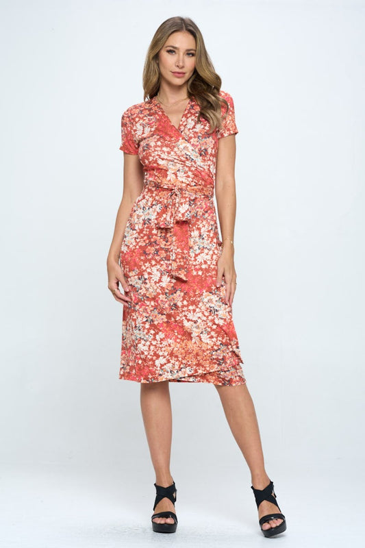 This floral tie front surplice short sleeve dress is a delightful and charming choice for any summertime occasion. The feminine floral print adds a touch of whimsy and romance to the dress. The surplice neckline is flattering and stylish, creating an elegant silhouette.  S - L