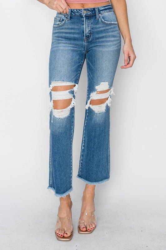 These Mid Rise Distressed Cropped Flare Jeans are a trendy and edgy addition to your denim collection. The mid-rise fit offers a flattering and comfortable silhouette, while the distressed detailing adds a touch of rugged charm.  0 - 15