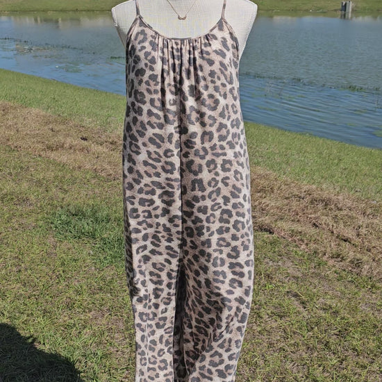 Leopard jumpsuit with side slits, adjustable straps, functional pockets. Sizes small through x-large.