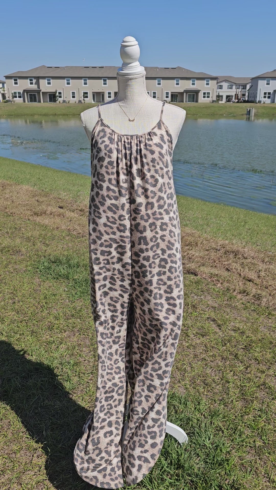 Leopard jumpsuit with side slits, adjustable straps, functional pockets. Sizes small through x-large.