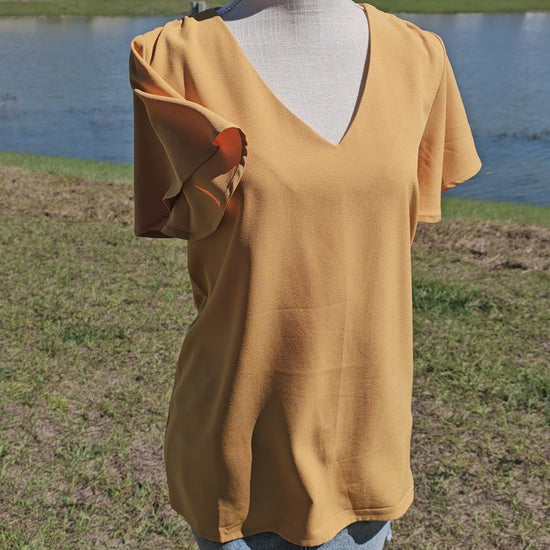 Harvest some style in this Dandelion Fields Golden Mustard Top! Featuring a woven flutter sleeve v-neck - it's the perfect outfit choice to spice up any look! Guaranteed to make you stand out like a ray of sunshine. Sizes small through x-large.