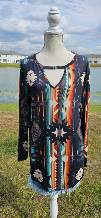 This is a comfy and casual long sleeve top. It features a rounded neckline with a V shaped cutout, long sleeves, Aztec design.  Imagine yourself going to the rodeo, or line dancing.  Whatever your adventure is, this is the shirt! Sizes small through x-large.