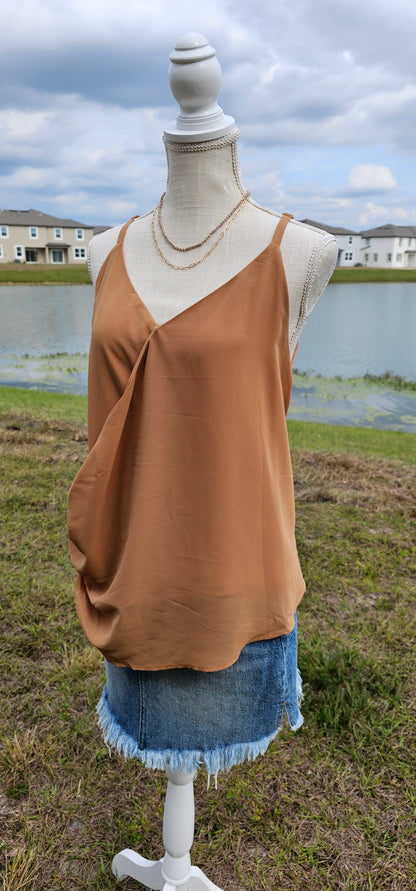 “Frappuccino” is a woven double layer chiffon top, featuring buttons up the side, surplice neckline, and adjustable spaghetti straps. This top is perfect for layering or great all by itself. Sizes small through x-large.