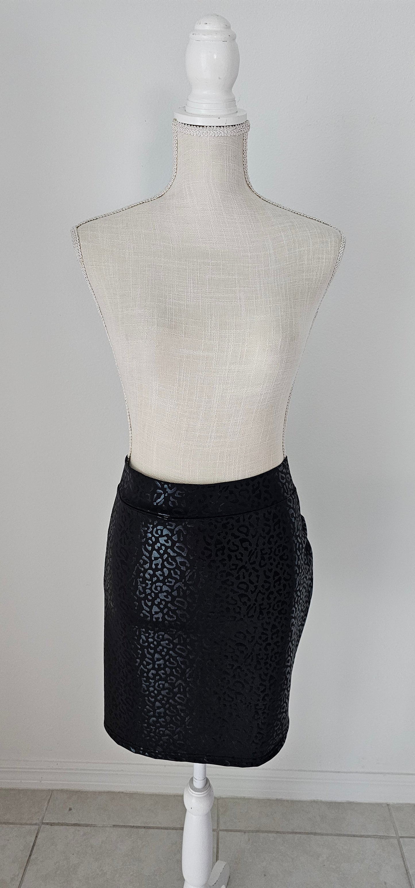 Imagine yourself in this cute little black skirt. This is a fitted mini skirt that is super edgy and chic. You'll be sure to turn heads in this skirt. It features a glossy animal print that is black, and a stretchy waist band. Go ahead and strut your stuff girl! Sizes small through x-large.